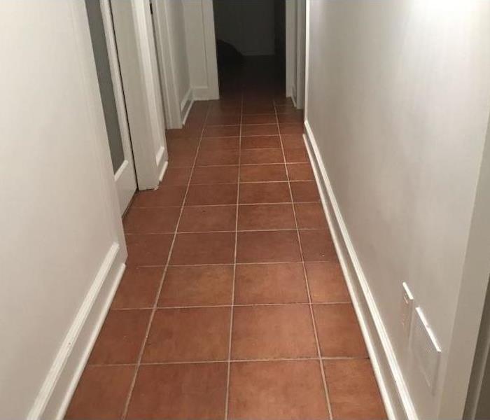 Hallway with white walls and tile floor