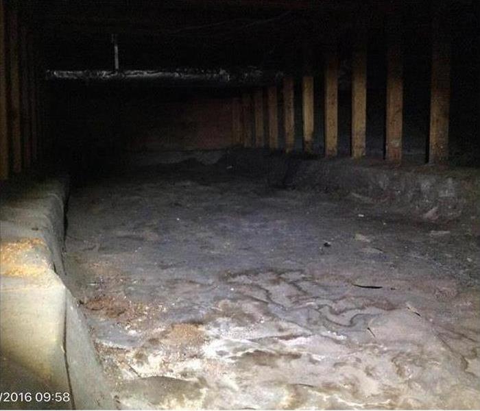 crawlspace with debris after the water removal