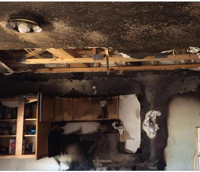 fire damaged kitchen, soot covering ceiling with demolition