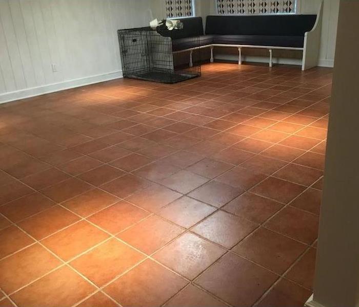 Dog crate and seating on a tile floor